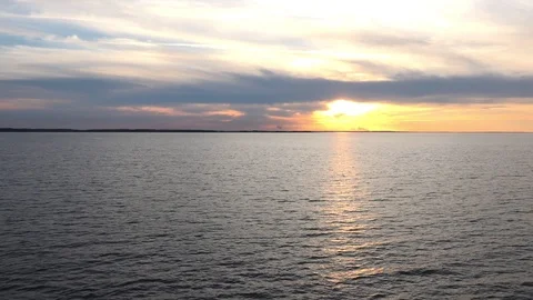 Fantastic sunset above calm boundless violet ocean surface Stock Footage 113093741