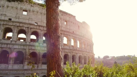 Fantastic tracking shot with gimbal on the facade of the Colosseum on a sunny Stock Footage 97048095