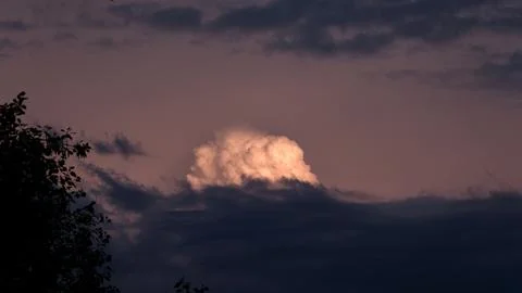 Fantastic view of storm front with single cumulus cloud glowing brightly in the Stock Photos