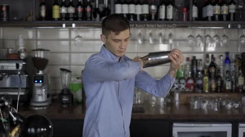 Fantastically beautiful bartender tosses two shakers Video stock 102742149