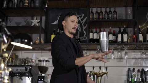 Fantastically beautiful bartender tosses two shakers Stock Footage 102742315