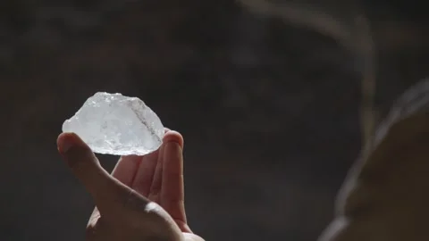 Fantasy character finds a valuable, magical gemstone in a dark cave or mine. Stock Footage 313339652