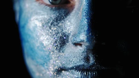 Fantasy makeup woman face blue shimmering paint Stock Footage 122681908