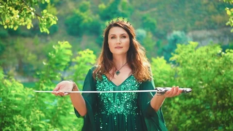 Fantasy portrait warlike red-haired woman queen holding silver sword in hands Stock Footage 311946176