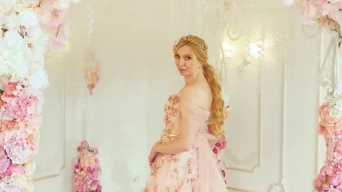 Fantasy princess in white room blooming spring scenery, flower decor arches rose Stock Footage 341732336