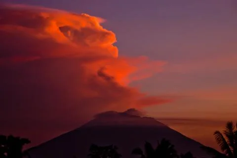 Fantasy shaped cloud over volcano in the sunset Stock Photos
