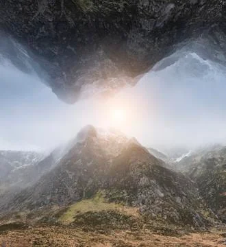 Fantasy surreal composite image of inverted mountain landscape above norma lm Stock Photos