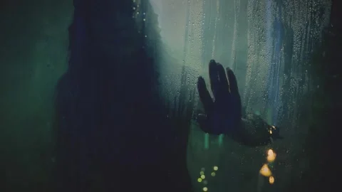 Fantasy vampire, woman ghost dark silhouette through wet glass with water drops Stock Footage 316255227