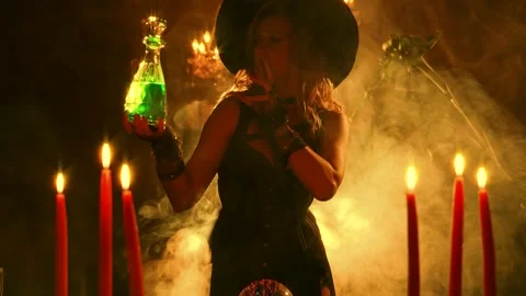 Fantasy woman witch creates magic in dark gothic room full smoke candle fire Stock Footage 311835063