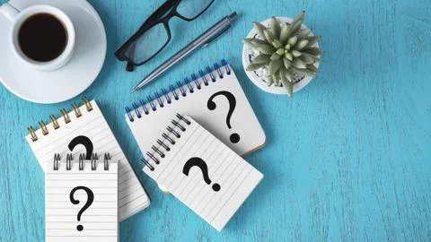 Faq concept with question marks on notepads, pen and coffee cup on blue woode Stock Photos
