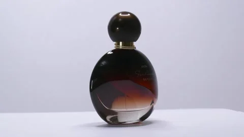 Far Away Beyond by Avon Perfume bottle rotation in studio Vídeo Stock 171577167