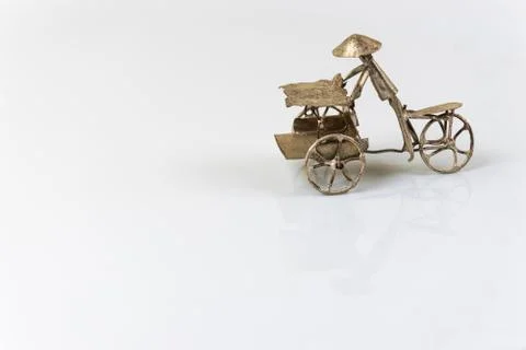 Far eastern three wheel bicycle figurine isolated on white backg Stock Photos