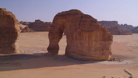 From far to flying through mountain hole Elephant Rock, Saudi Arabia. Aerial 4K Stock Footage 196849582