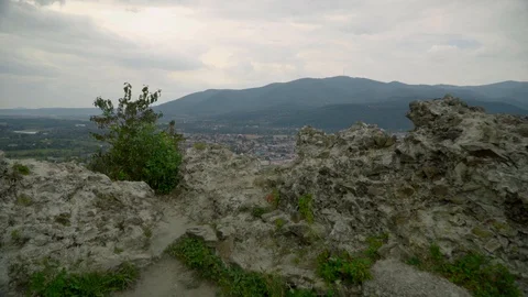 Far panoramic view of a town in basin from old Khust fortress with mountains and Stock Footage 114445040