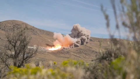 Far off view of hot fire test of a Space Launch System solid rocket booster Stock Footage 281724141