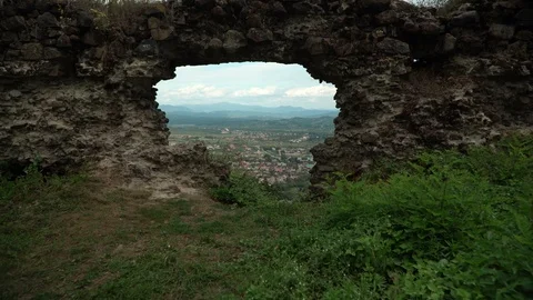 Far view of a town in basin from old Khust fortress with mountains and sky on Stock Footage 114443856