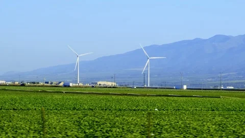 Far view of a wind turbine spinning Stock Footage 255925367