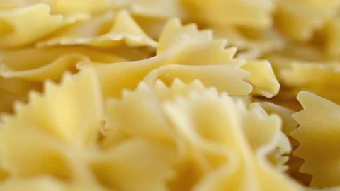 Farfalle, bow tie shaped dry pasta in rotation.Studio shot. Close Up, background Stock Footage 169061832