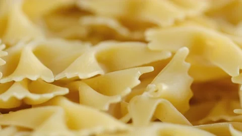 Farfalle, bow tie shaped dry pasta in rotation.Studio shot. Close Up, background Stock Footage 169282931