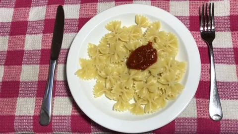 Farfalle with tomato paste on a white plate Stock Footage 105923901