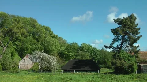 Farm buildings moving trees clouds rural scene Stock Footage 60431877