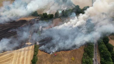 Farm fields on Fire UK drone aerial fire engines and large amount of smoke Stock Footage 346421619