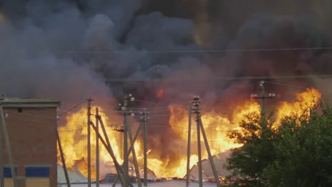 Farm fire. Burning industrial facility in village Stock Footage 235497546