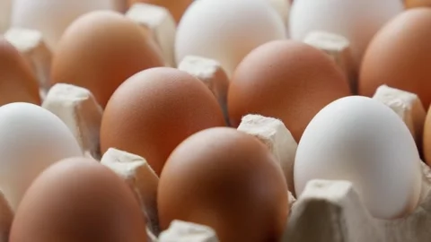 Farm fresh eggs in rustic paper tray rotating. Vertical footage. GMO free Video stock 308884178