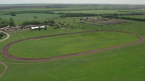 A farm with green meadows and fields. A farm with a race track Stock Footage 269955442