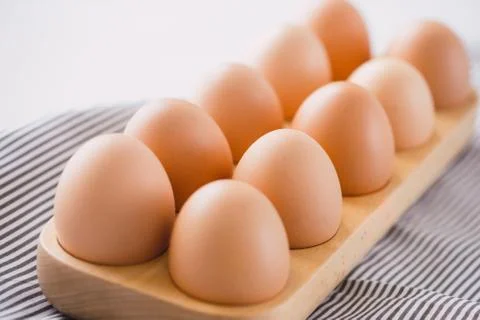 Farm raw fresh egg in pack on gray table ingredient for breakfast preparation Stock Photos