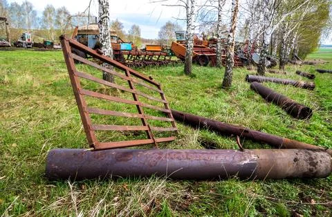 Farm scene with old rusty objects in the field Stock Photos
