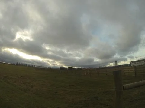 Farm sunset with clouds Stock Photos