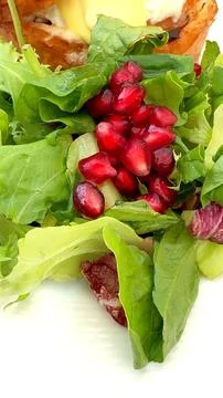 Farm-to-table breakfast featuring pomegranate seeds and fresh greens. This eco Stock Photos