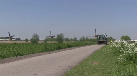 Farm tractor and windmills Stock Footage 24692217
