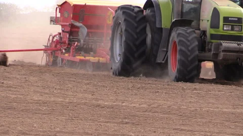 Farm tractor with device makes furrow in field Stock Footage 47856010