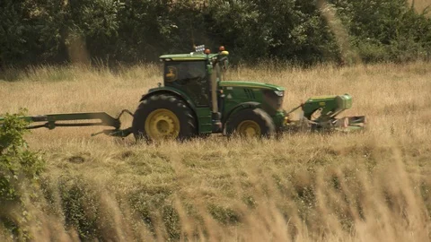 Farm tractor mowing a meadow Stock Footage 106391027