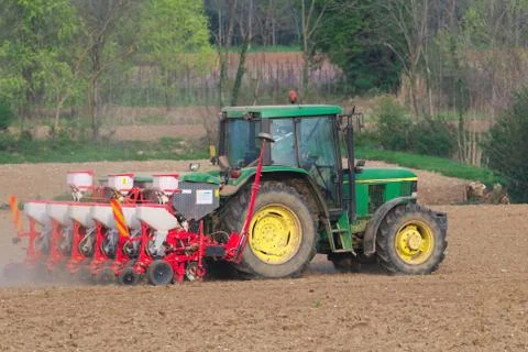 Farm tractor with seeder Stock Photos