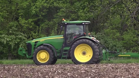 Farm tractor seeding with man and child Stock Footage 75096038