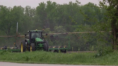 Farm tractor seeding with man and child Stock Footage 75097508