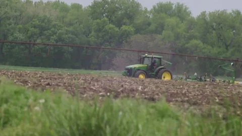 Farm tractor seeding with man and child Stock Footage 75097530