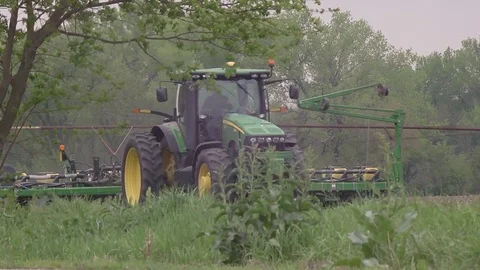 Farm tractor seeding with man and child Stock Footage 75100184