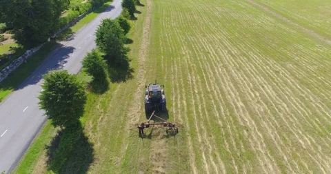 Farm tractor working in the field. Aerial footage. Stock Footage