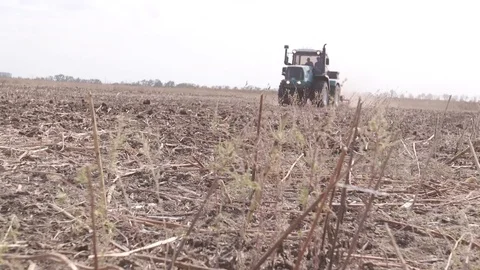 Farm tractor working in a field 库存影片 82934557