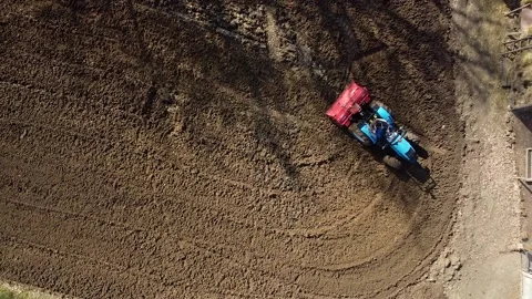 Farm tractor working soil, top down view. Tilling soil Stock Footage 153054032
