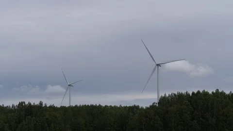 Farm wind turbines that work in the forest. 4K Slow Mo Stock Footage 114891035