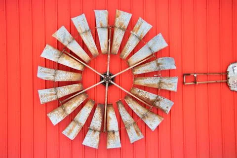 Farm windmill blade mounted on the side of a wall Stock Photos