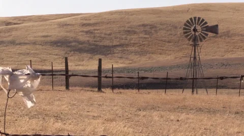 Farm, Windmill pumping dust, plastic bag Stock Footage 39419398