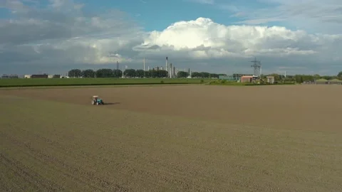 Farmer and refinery [drone] Stock Footage 131649786