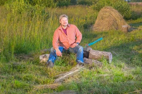 Farmer with an axe sitting Stock Photos