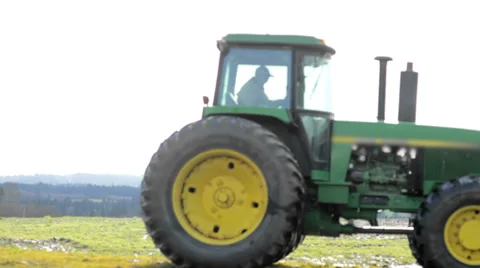 A farmer backs up a his tractor Stock Footage 33996274
